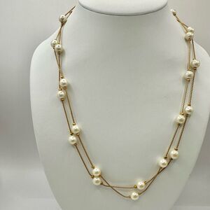 Gold tone and faux pearl long necklace
